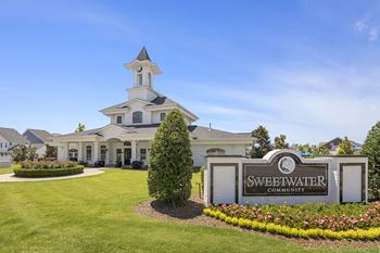 the sweetwater community building with a sign in front of it